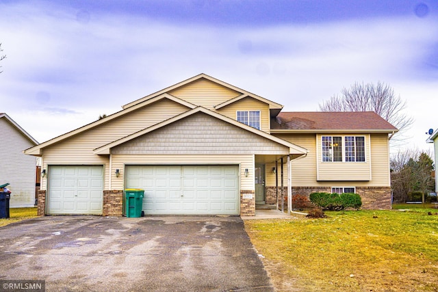 view of front of house with a front yard and a garage