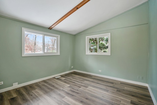 empty room with lofted ceiling with beams and hardwood / wood-style flooring