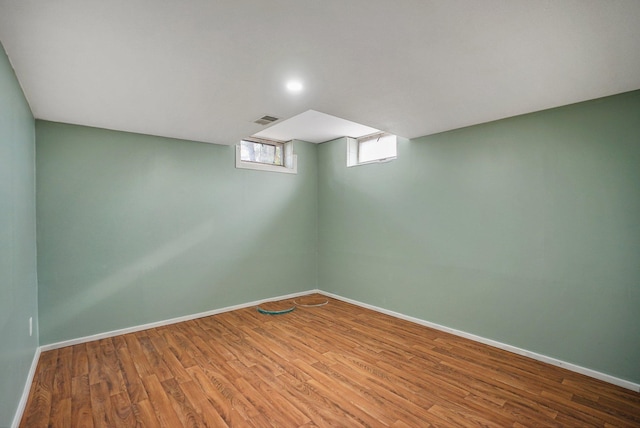 basement with hardwood / wood-style floors