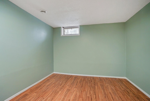 basement with light hardwood / wood-style floors