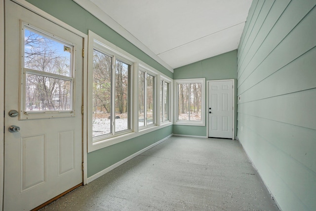 unfurnished sunroom featuring a wealth of natural light and vaulted ceiling