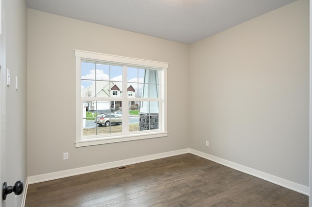 spare room featuring dark hardwood / wood-style floors