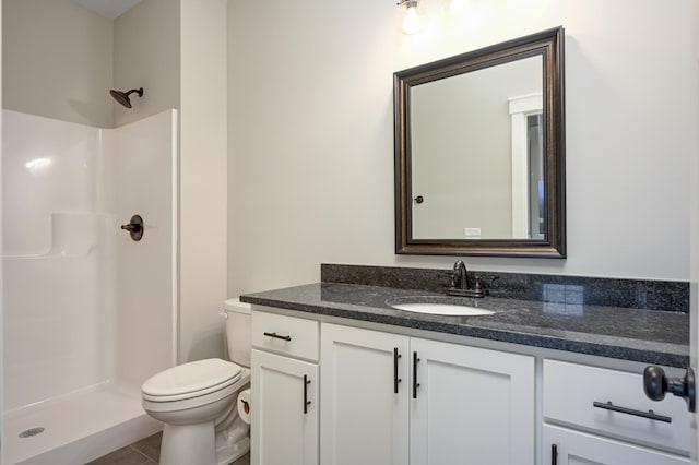 bathroom with tile patterned floors, vanity, toilet, and walk in shower