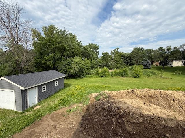 8001 Petunia St, Victoria, MN 55386 - view of green lawn with an outbuilding and a garage