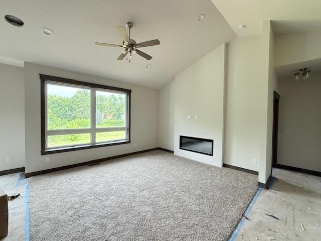 8001 Petunia St, Victoria, MN 55386 - unfurnished living room with vaulted ceiling, ceiling fan, a glass covered fireplace, and recessed lighting