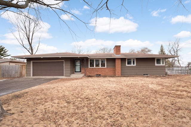 single story home featuring driveway, a chimney, an attached garage, fence, and brick siding