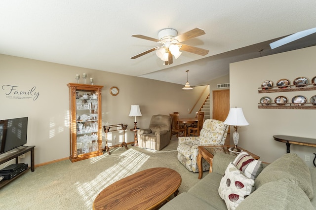 living room featuring carpet, ceiling fan, and lofted ceiling with skylight