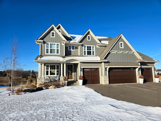 craftsman-style home featuring covered porch and a garage