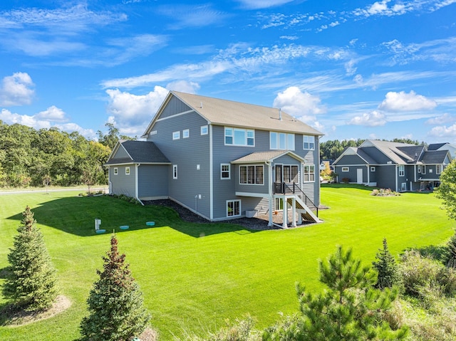 rear view of property with a yard