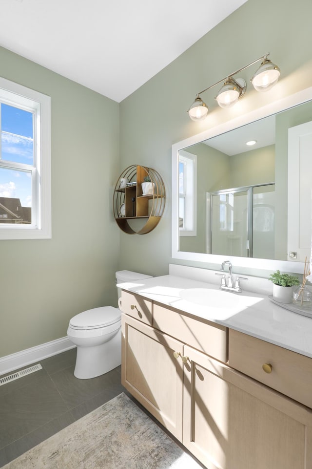 bathroom featuring vanity, toilet, tile patterned flooring, and an enclosed shower