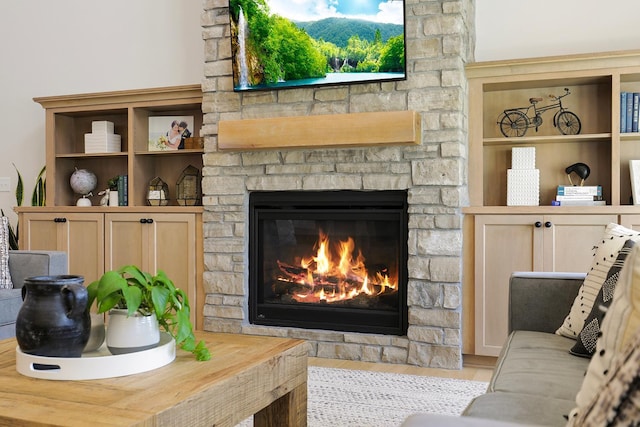 interior space featuring a stone fireplace and hardwood / wood-style floors