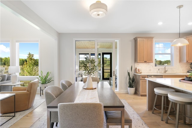 dining area featuring light hardwood / wood-style floors and sink