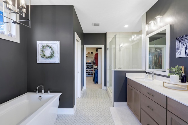 bathroom featuring separate shower and tub, vanity, and a chandelier