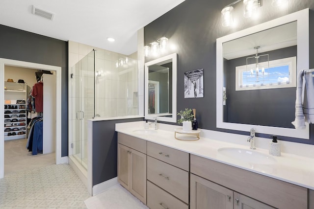 bathroom featuring an enclosed shower and vanity