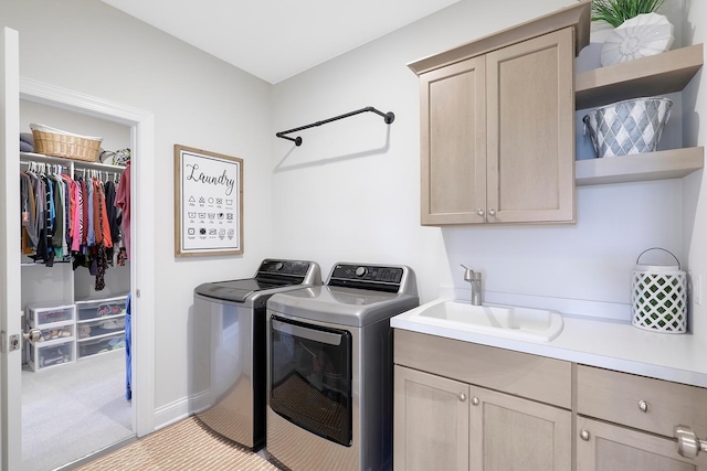 washroom with light carpet, independent washer and dryer, sink, and cabinets