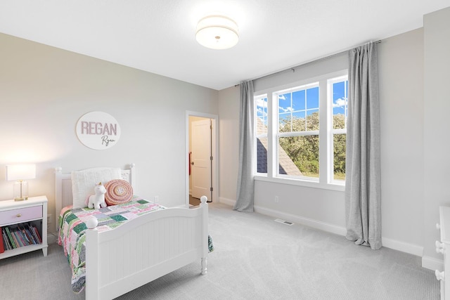 bedroom featuring light colored carpet