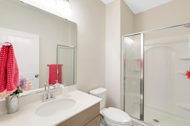 bathroom with an enclosed shower, vanity, and toilet