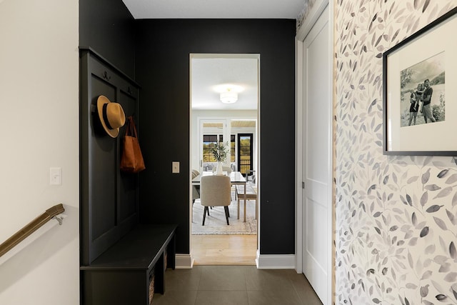 mudroom with dark tile patterned flooring