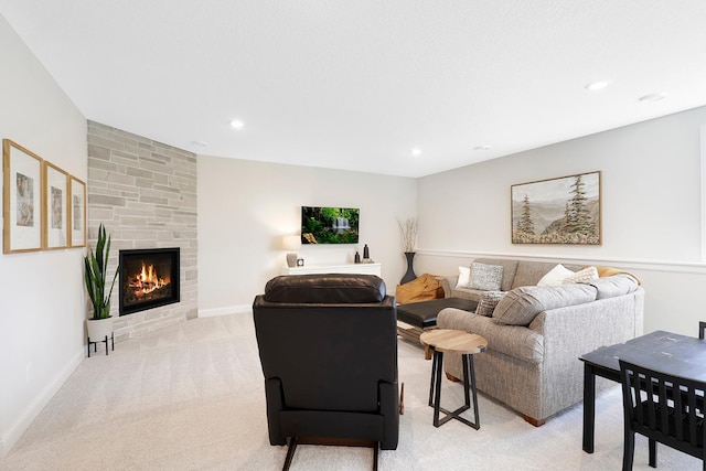 living room with light carpet and a fireplace