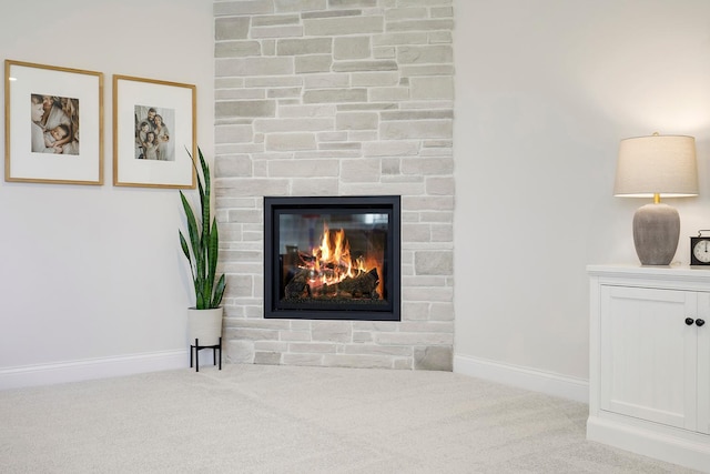 interior details with carpet floors and a stone fireplace