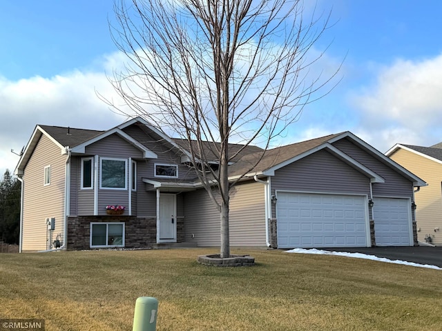 view of front of property featuring a garage and a front lawn