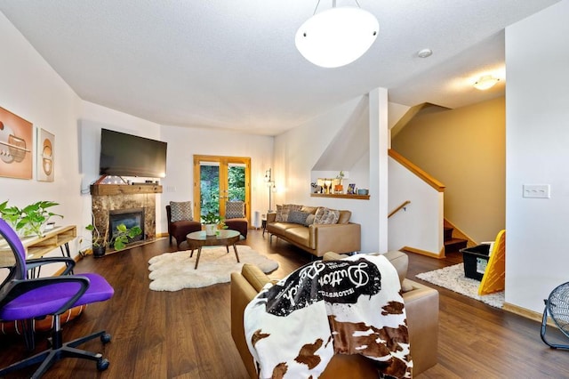 living room with a fireplace and wood-type flooring