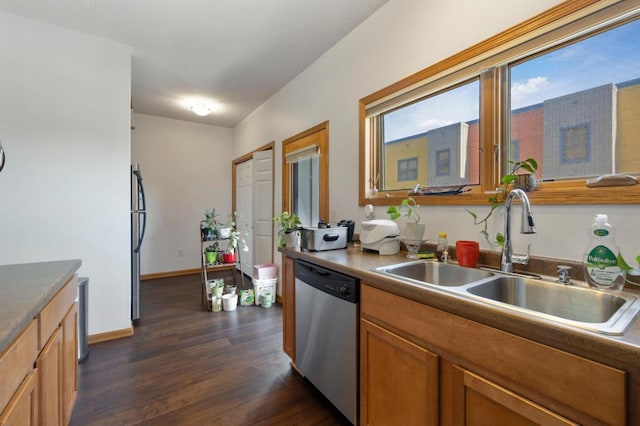 kitchen with stainless steel appliances, dark wood-type flooring, and sink