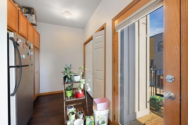 interior space with stainless steel refrigerator and dark wood-type flooring