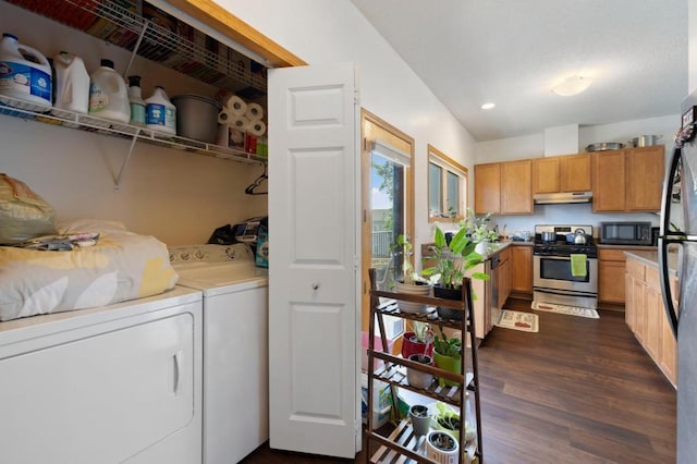 clothes washing area featuring separate washer and dryer and dark hardwood / wood-style floors