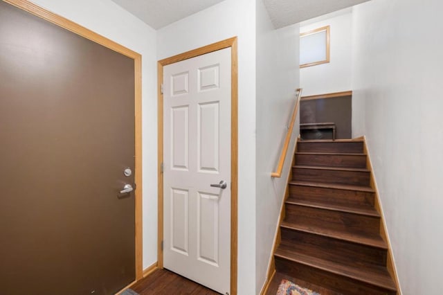 stairs featuring hardwood / wood-style flooring