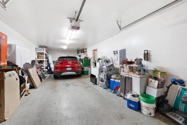 garage with electric panel and a garage door opener