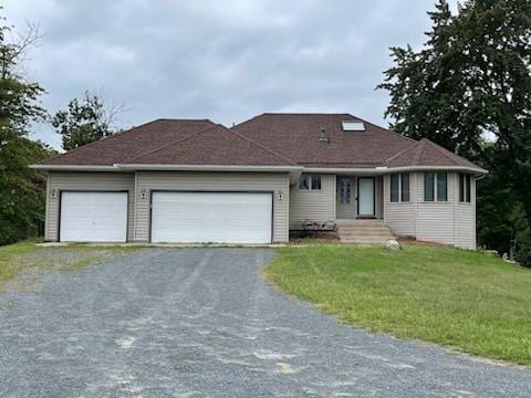 ranch-style home with a front lawn and a garage