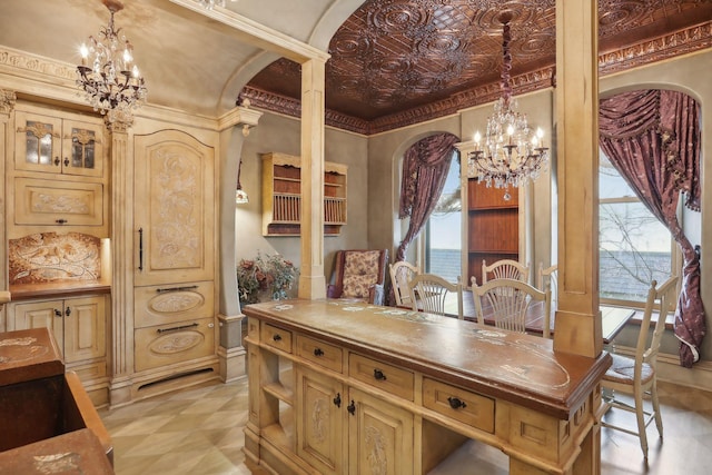 kitchen featuring a wealth of natural light, hanging light fixtures, and crown molding