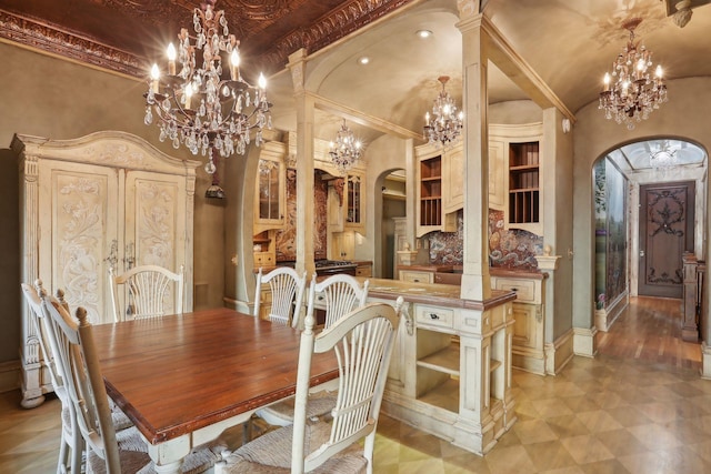 dining space with an inviting chandelier, high vaulted ceiling, and crown molding