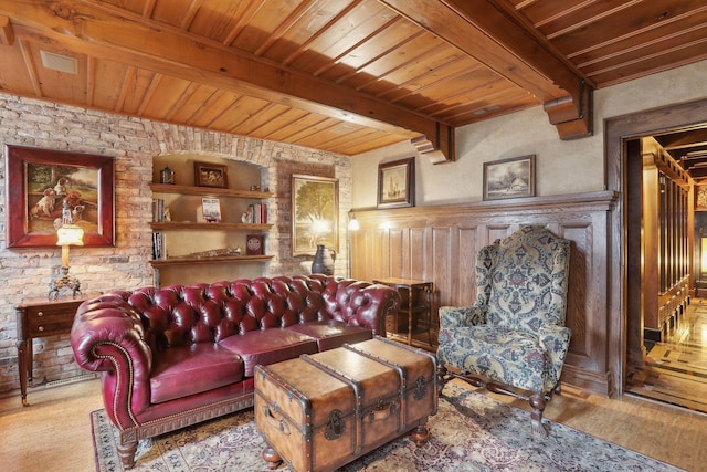 living room featuring built in shelves, beam ceiling, and wood ceiling