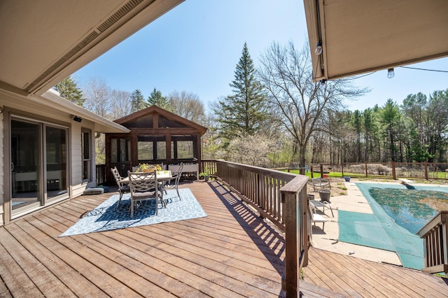 deck with fence, a fenced in pool, and outdoor dining area