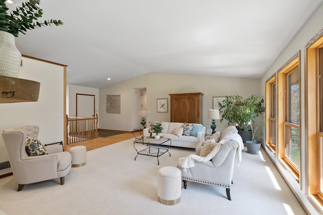 living room featuring carpet floors and vaulted ceiling