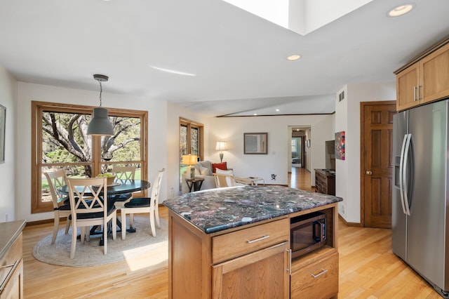 kitchen featuring dark stone counters, stainless steel appliances, recessed lighting, and light wood-type flooring