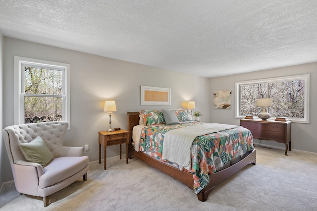carpeted bedroom featuring baseboards, multiple windows, and a textured ceiling