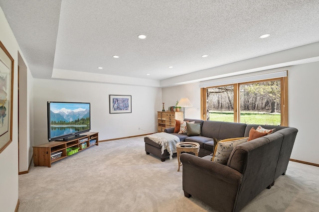 living room featuring light colored carpet, a textured ceiling, baseboards, and recessed lighting