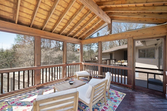 sunroom featuring plenty of natural light and beamed ceiling