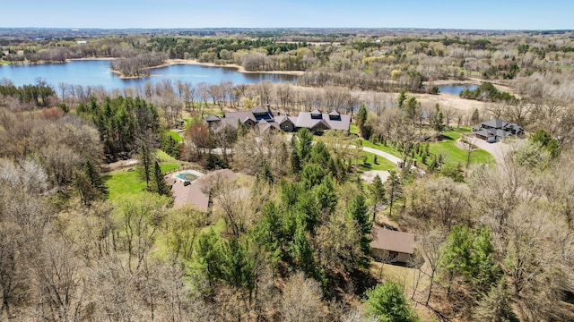aerial view featuring a water view and a wooded view