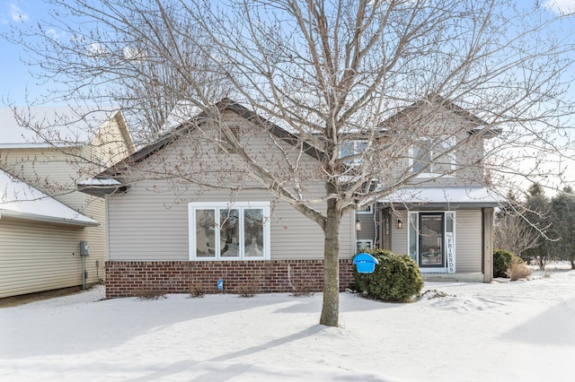 view of snow covered rear of property