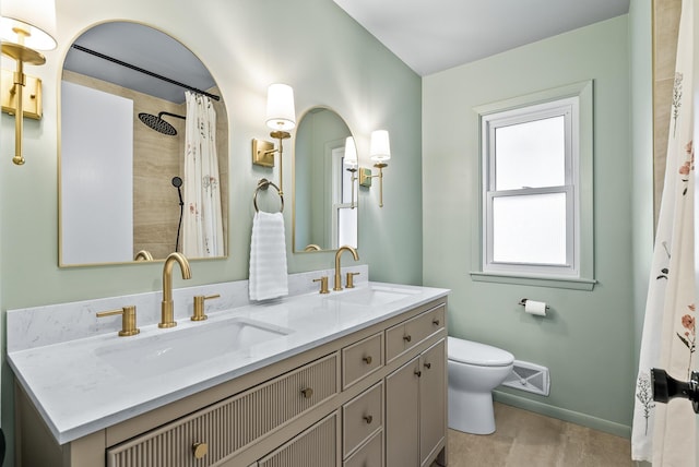 full bath with toilet, double vanity, baseboards, and wood finished floors