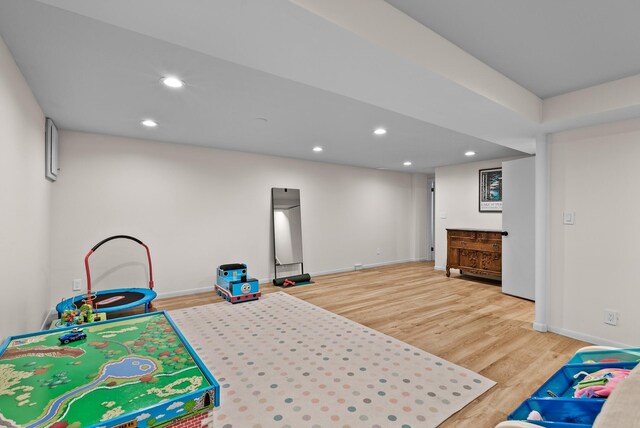 recreation room with baseboards, wood finished floors, and recessed lighting