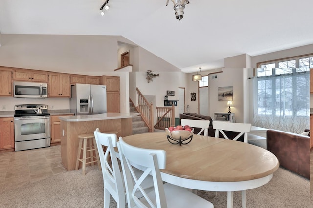 dining room with high vaulted ceiling