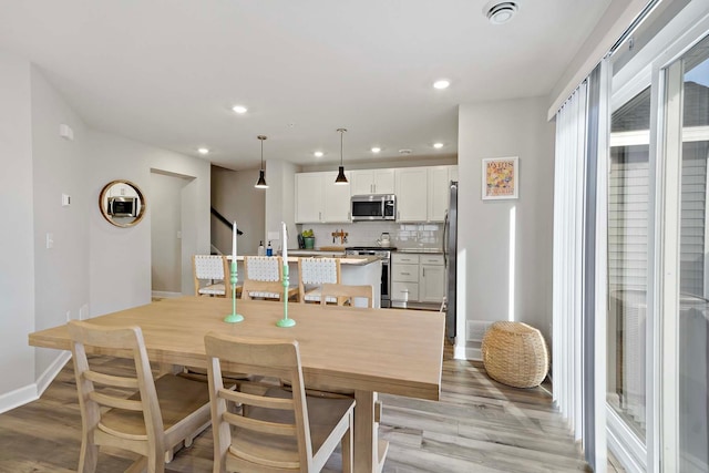 dining area featuring sink and light hardwood / wood-style flooring