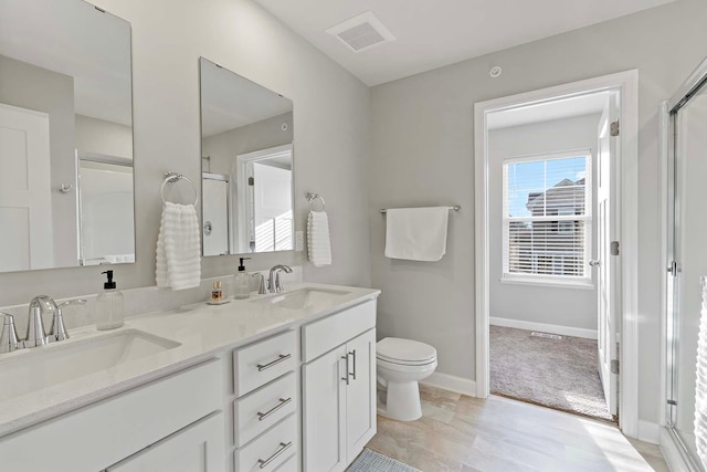 bathroom featuring toilet and vanity