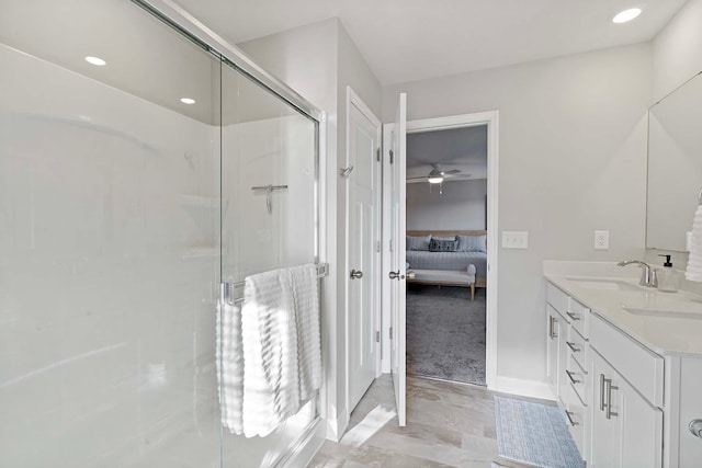 bathroom featuring vanity and a shower with shower door