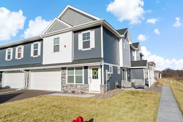 view of front of home with a garage and a front lawn